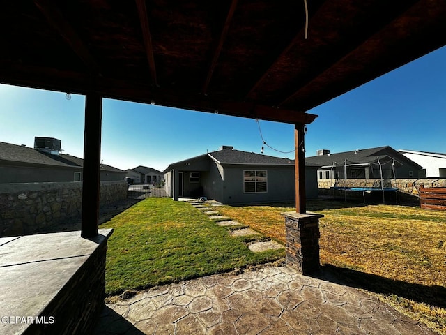 view of yard with a patio and a trampoline