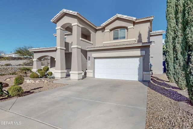 mediterranean / spanish house featuring a garage