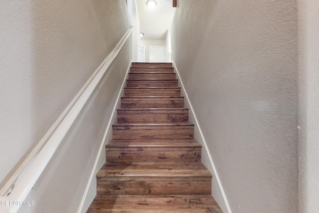 stairs featuring hardwood / wood-style floors