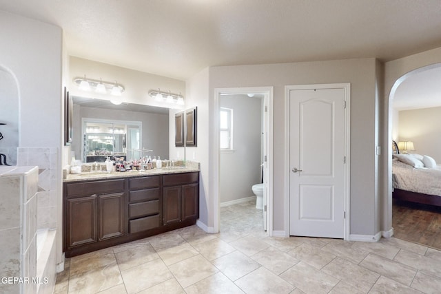 bathroom with hardwood / wood-style floors, vanity, and toilet