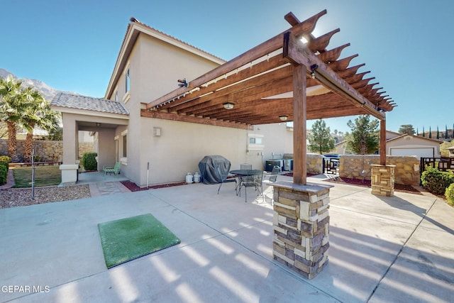 view of patio with area for grilling, a pergola, and grilling area