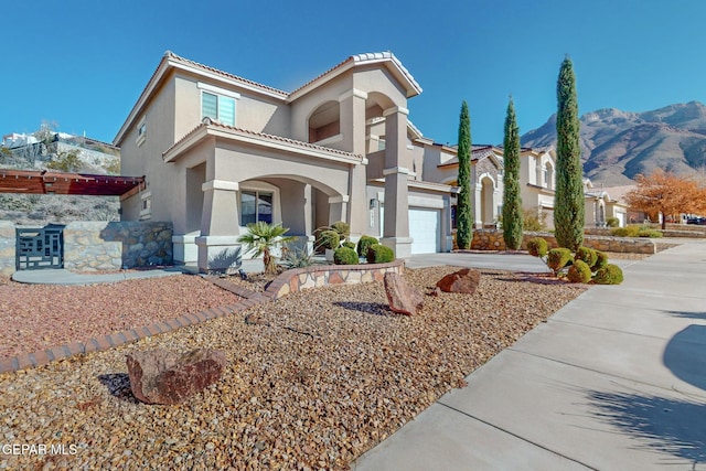 mediterranean / spanish home featuring a mountain view and a garage