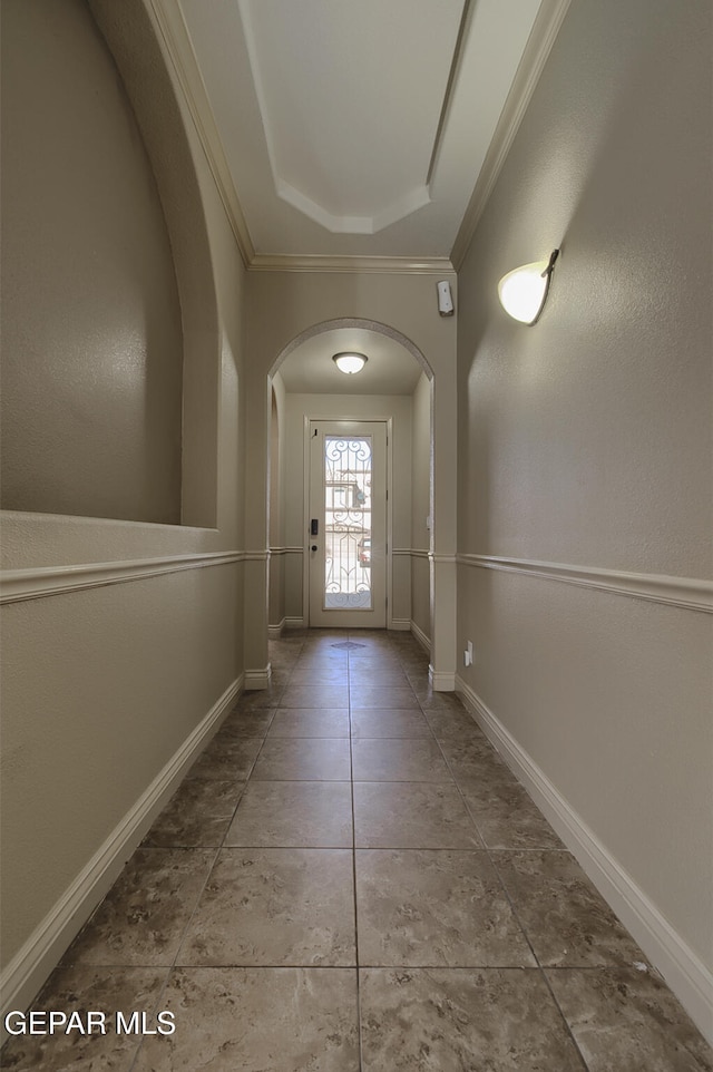 entryway featuring tile patterned floors and ornamental molding