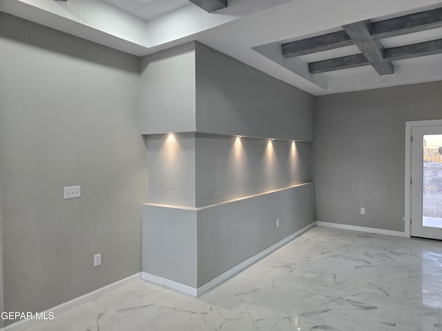 spare room with beamed ceiling and coffered ceiling