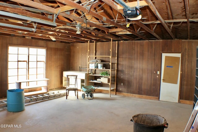 interior space with wooden walls and a garage door opener