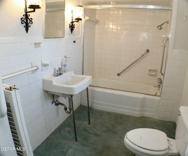 bathroom with tiled shower / bath combo, toilet, tile walls, and radiator