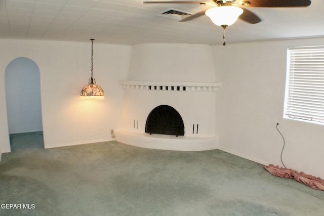 unfurnished living room with carpet flooring and ceiling fan