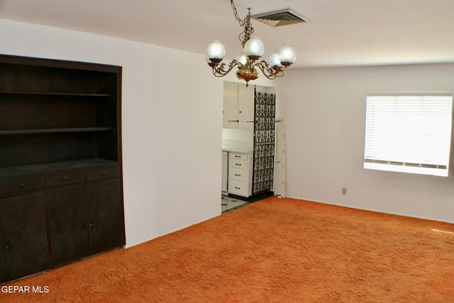 unfurnished dining area with carpet flooring and an inviting chandelier