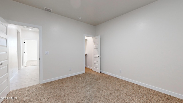 unfurnished bedroom featuring light colored carpet