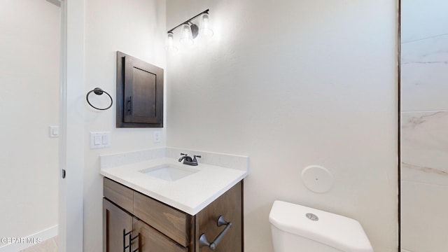 bathroom featuring vanity and toilet