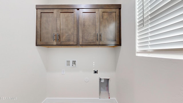 washroom featuring hookup for an electric dryer, hookup for a washing machine, hookup for a gas dryer, and cabinets