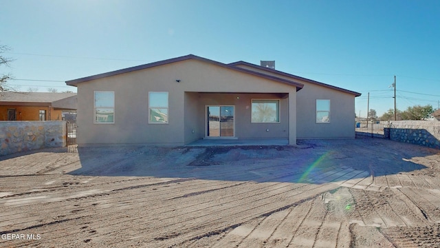 back of property with a patio