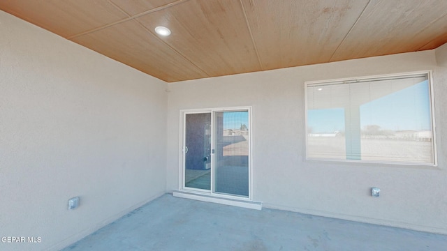 interior space featuring concrete flooring and wood ceiling