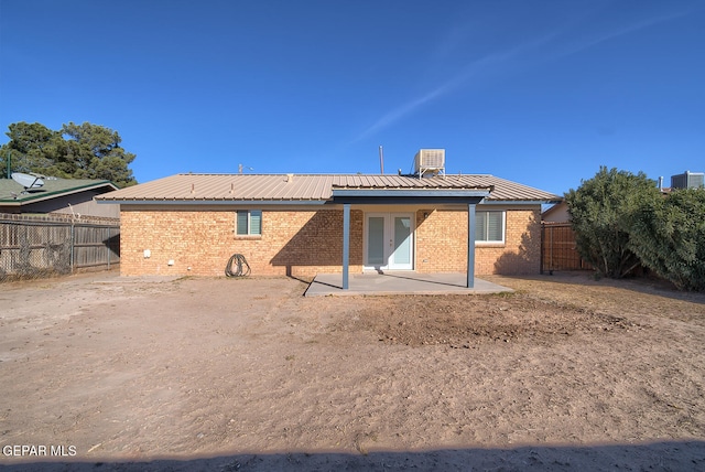 rear view of house featuring a patio area and cooling unit