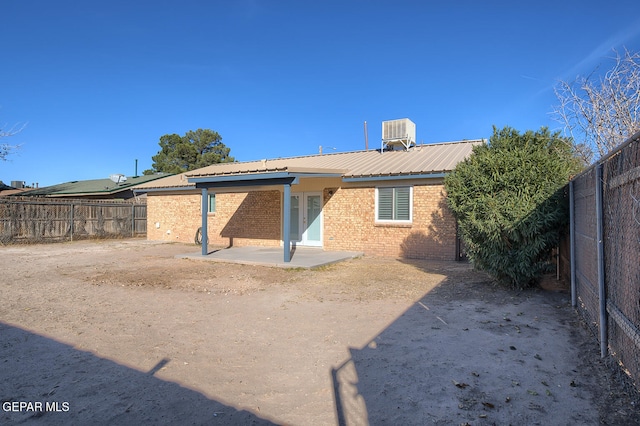 back of property featuring central AC and a patio