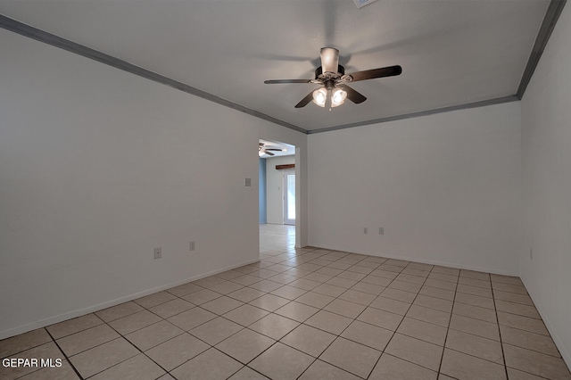 tiled empty room with ceiling fan and crown molding