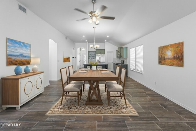 dining area with ceiling fan with notable chandelier and vaulted ceiling