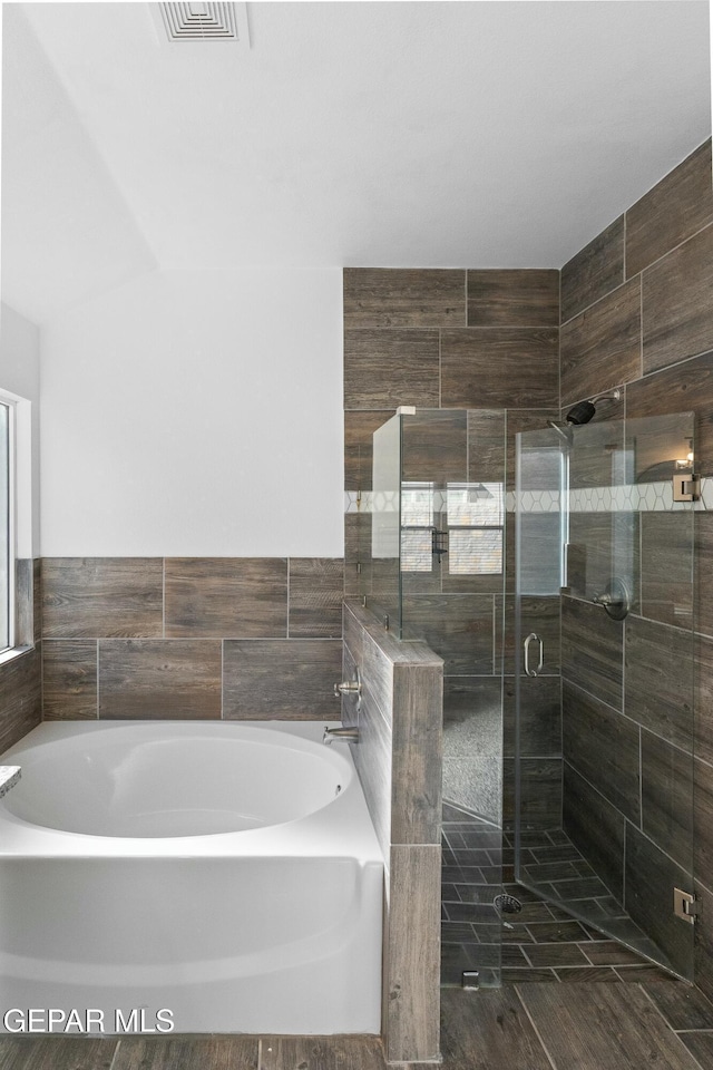 bathroom with shower with separate bathtub