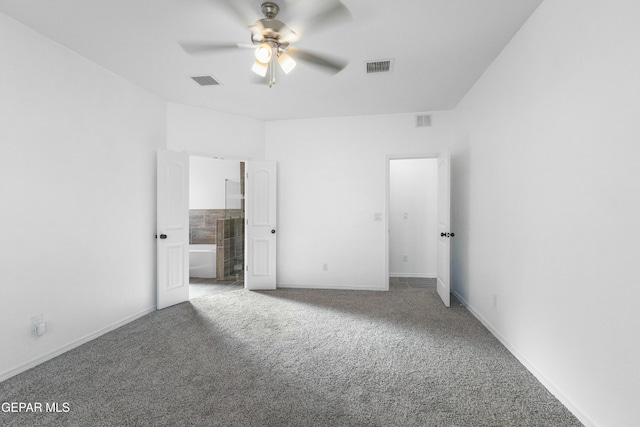 unfurnished bedroom featuring carpet flooring, ceiling fan, and connected bathroom