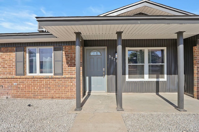 doorway to property featuring covered porch