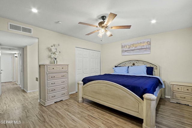 bedroom with ceiling fan, light hardwood / wood-style floors, and a closet