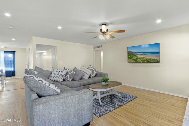 living room with ceiling fan and light hardwood / wood-style floors