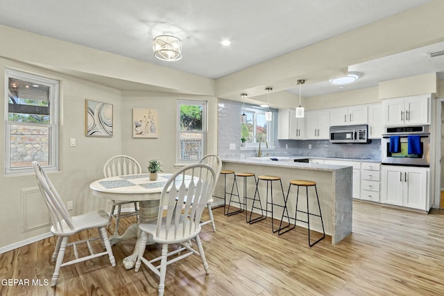 interior space with light hardwood / wood-style flooring and sink