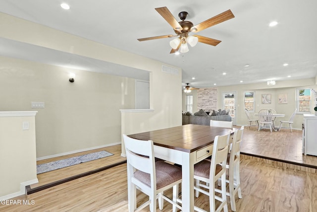 dining room featuring light wood-type flooring and ceiling fan