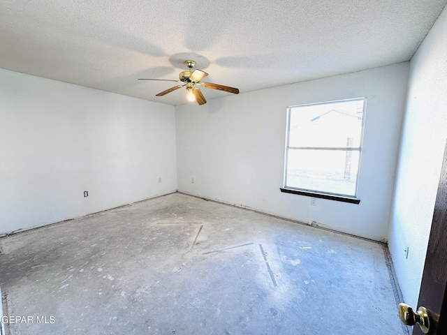 spare room with ceiling fan and a textured ceiling