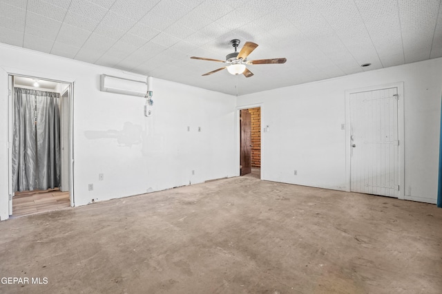 interior space featuring ceiling fan, concrete flooring, and a wall unit AC