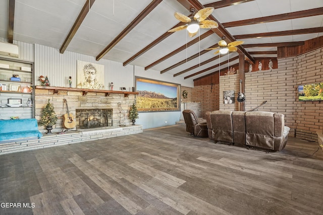 unfurnished living room featuring vaulted ceiling with beams, a stone fireplace, brick wall, and hardwood / wood-style flooring