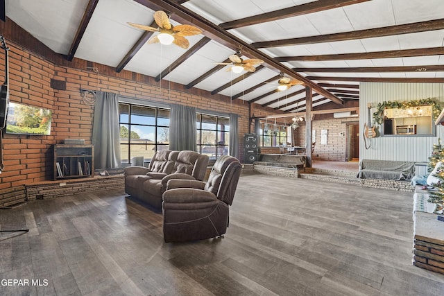 living room with lofted ceiling with beams, hardwood / wood-style flooring, and brick wall