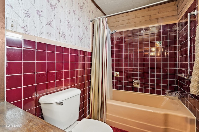 bathroom featuring shower / bath combination with curtain, tile walls, and toilet