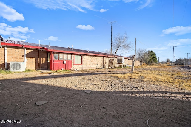 525 N Main St, Dell City, TX 79837 - back of property featuring a metal roof and brick siding