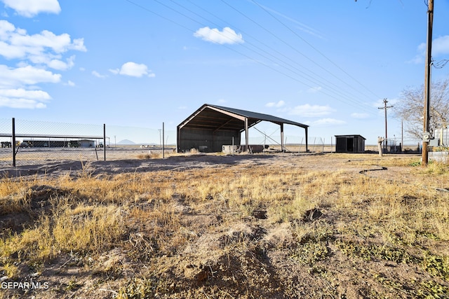 view of yard featuring a carport and a rural view