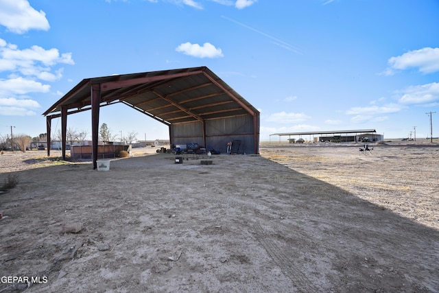 525 N Main St, Dell City, TX 79837 - view of yard featuring a detached carport, driveway, an outbuilding, and a pole building