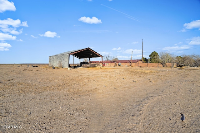 view of yard with a rural view and an outdoor structure