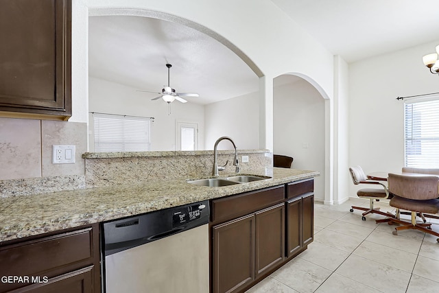 kitchen with light stone countertops, stainless steel dishwasher, ceiling fan, sink, and light tile patterned flooring