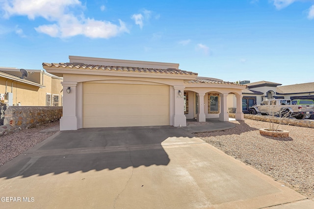 mediterranean / spanish-style home with a garage