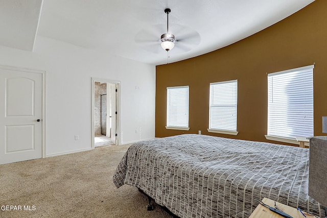 carpeted bedroom featuring ensuite bath and ceiling fan