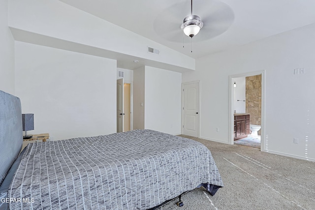 carpeted bedroom featuring ensuite bath, ceiling fan, and lofted ceiling