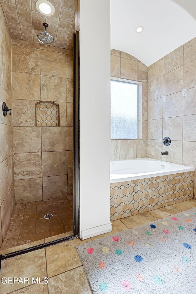 bathroom featuring tile patterned flooring and shower with separate bathtub