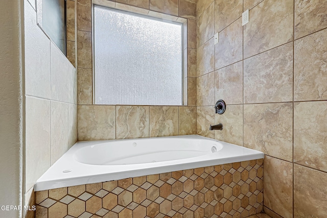 bathroom featuring tiled tub