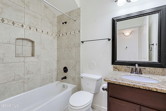 full bathroom with vanity, toilet, and tiled shower / bath