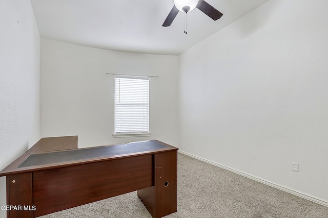 unfurnished office featuring light carpet and ceiling fan