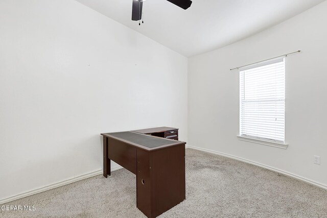 carpeted office space with ceiling fan