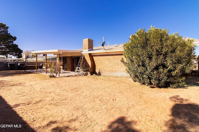 rear view of property featuring a patio area