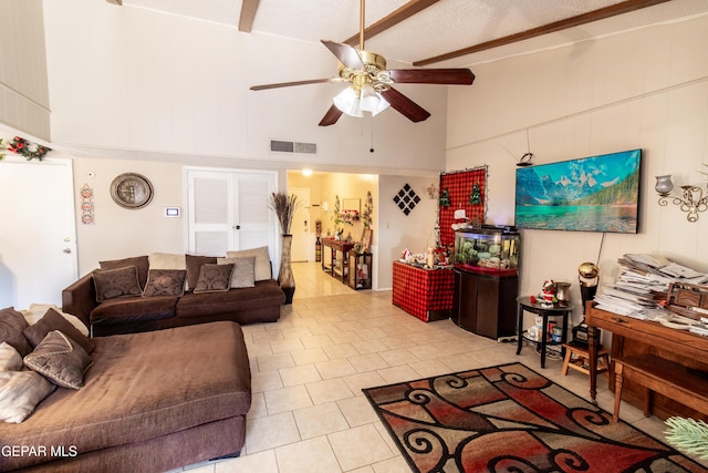 tiled living room with ceiling fan, a textured ceiling, and high vaulted ceiling