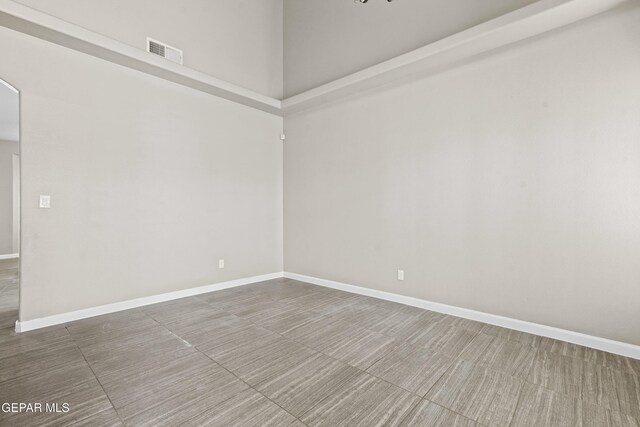 unfurnished room featuring a high ceiling