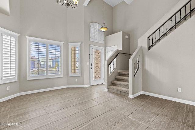 entryway with a high ceiling and a notable chandelier